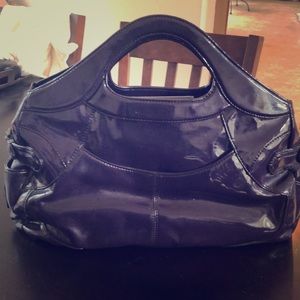 Purple patent handbag with zebra print lining